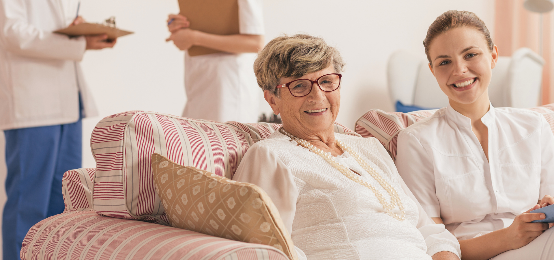 Two women laughing together on a couch