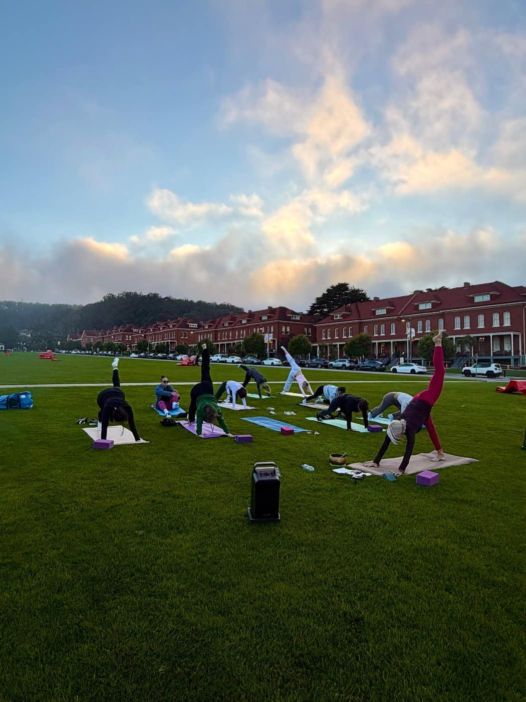 Outdoor yoga flow led by True Balance Yoga with Devon on the Presidio’s Main Parade Lawn at sunset